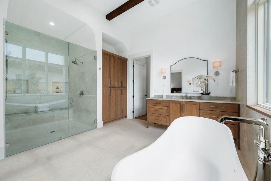 Full bathroom with vanity, a freestanding tub, a stall shower, and beamed ceiling Full bathroom with vanity, a freestanding tub, a stall shower, and beamed ceiling