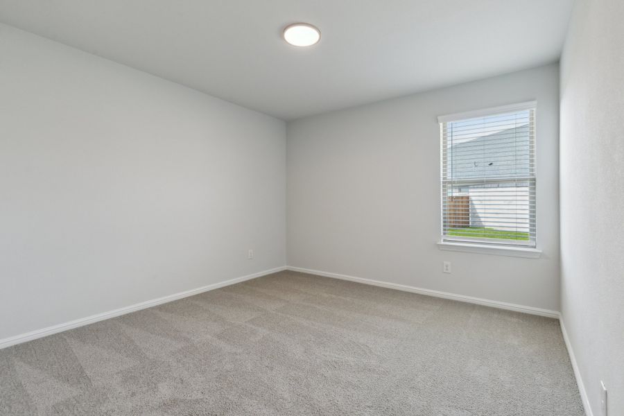 Bedroom in the Hayden home plan by Trophy Signature Homes – REPRESENTATIVE PHOTO