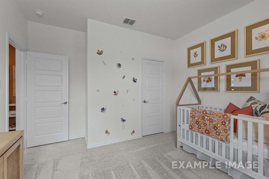 Carpeted bedroom with a nursery area