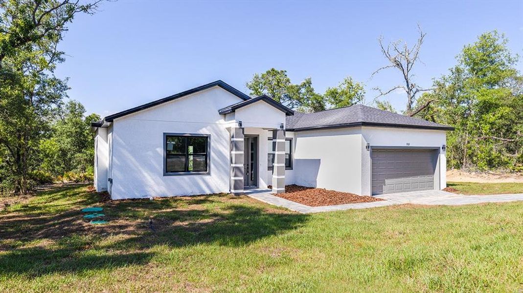 Front exterior of a new home in , Citrus Springs, FL, highlighting curb appeal (Image 2). Front exterior of a new home in , Citrus Springs, FL, highlighting curb appeal (Image 2).