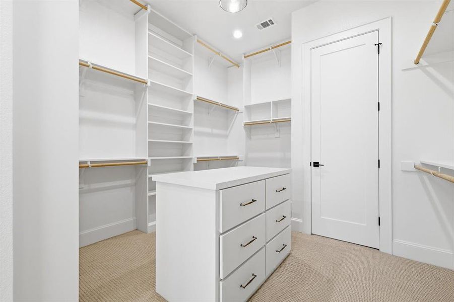 Large Primary Closet with 3 rows of racks. Large Primary Closet with 3 rows of racks.
