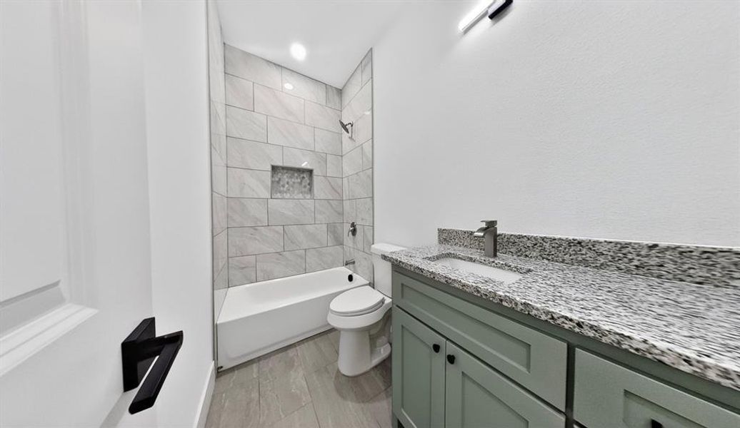 Full bathroom featuring vanity, bathing tub / shower combination, and recessed lighting