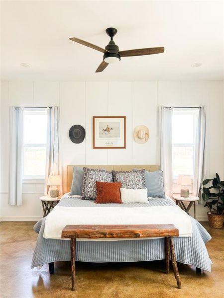 Bedroom with a ceiling fan and a decorative wall Bedroom with a ceiling fan and a decorative wall