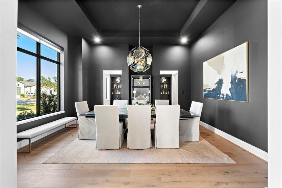 This breathtaking formal dining room right off the entry showcases incredible combinations of natural light, gorgeous light fixtures, designer window treatments and trey ceilings.