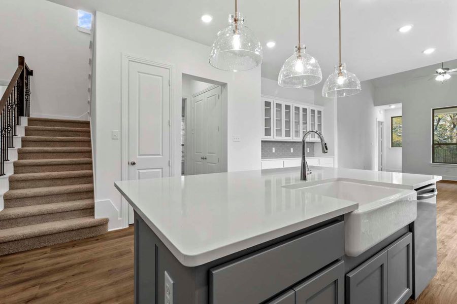 Kitchen featuring gray cabinets, a kitchen island with sink, hanging light fixtures, dark wood-style flooring, and recessed lighting Kitchen featuring gray cabinets, a kitchen island with sink, hanging light fixtures, dark wood-style flooring, and recessed lighting