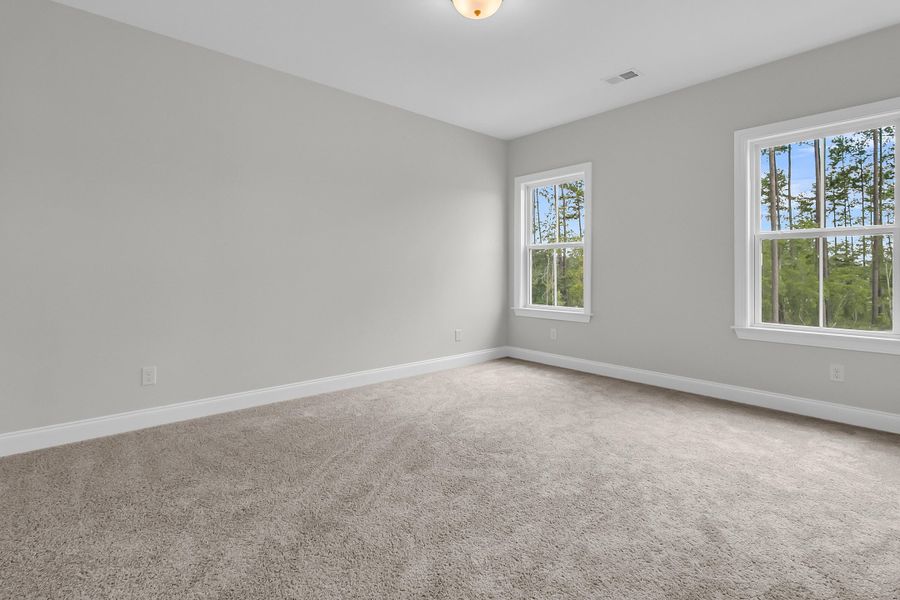 Spacious, unfurnished interior of a new home in Tidewater at Lakes of Cane Bay, Summerville (Image 46).