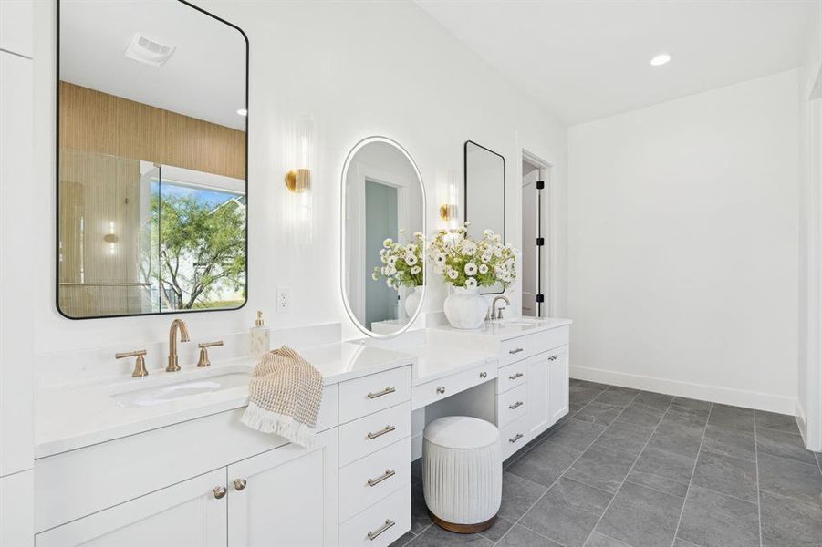 Vanity with lit mirror ensures perfect makeup every time; so much storage in this extra-long vanity setup. Don't miss the huge walk-in closet!