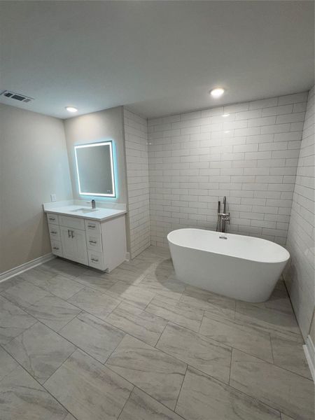 stand alone soaker tub primary bath 2nd floor. Laso huge walk in shower in another picture