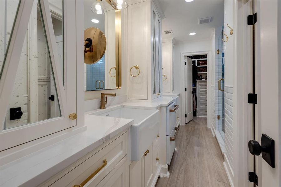 Bathroom featuring a shower with door, vanity, and hardwood / wood-style flooring