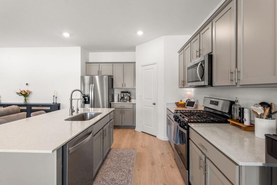 Modern kitchen with sleek stainless steel appliances and abundant counter space. Modern kitchen with sleek stainless steel appliances and abundant counter space.