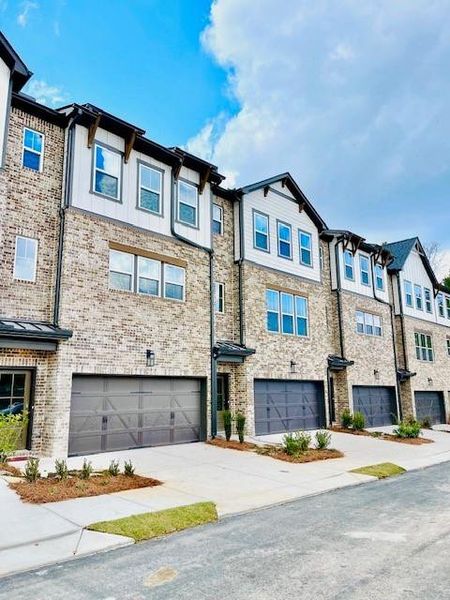 Front exterior of a new home in Towne Village at Suwanee Dam, Sugar Hill, GA, highlighting curb appeal (Image 1).