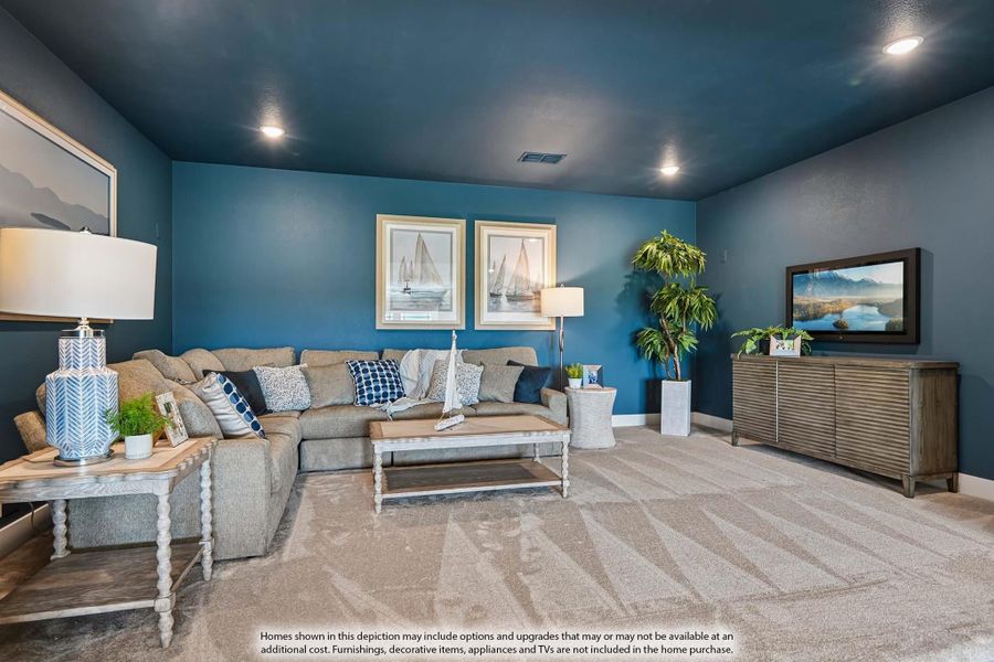Living room with blue walls, gray sectional sofa, carpet flooring, and wall-mounted TV Living room with blue walls, gray sectional sofa, carpet flooring, and wall-mounted TV