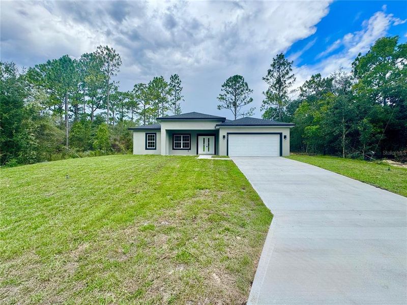 Front exterior of a new home in , Citrus Springs, FL, highlighting curb appeal (Image 2).