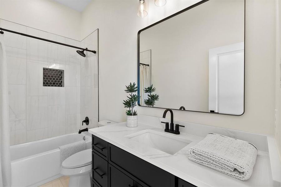 Bathroom with toilet, vanity, and shower / bath combo with shower curtain Bathroom with toilet, vanity, and shower / bath combo with shower curtain