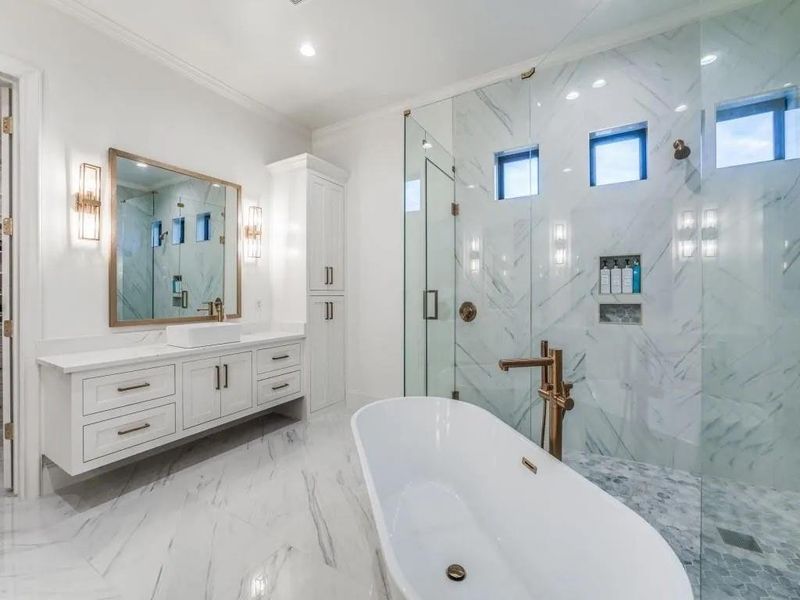 Full bath with vanity, a marble finish shower, a soaking tub, ornamental molding, and light marble finish floors