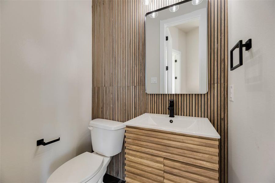 Half bathroom featuring toilet and vanity