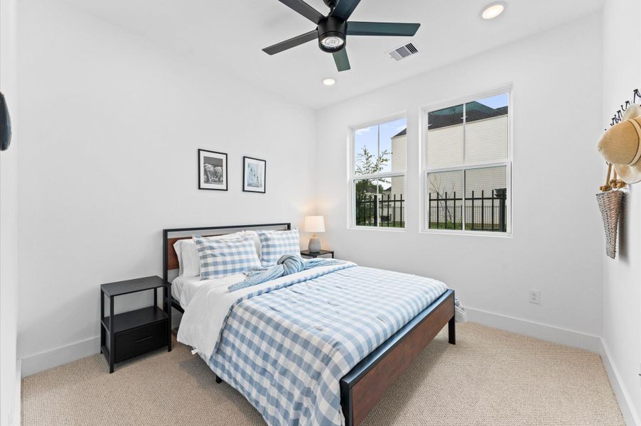 This inviting home features two spacious secondary bedrooms located on the first floor, offering privacy and convenience for guests, family members, or a home office setup. A full bathroom is thoughtfully positioned nearby, providing easy access and functionality. Whether used for multi-generational living or flexible space needs, this layout enhances comfort and accessibility without compromising style.