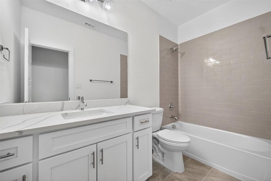 Full bathroom with shower / washtub combination, vanity, and light tile patterned flooring
