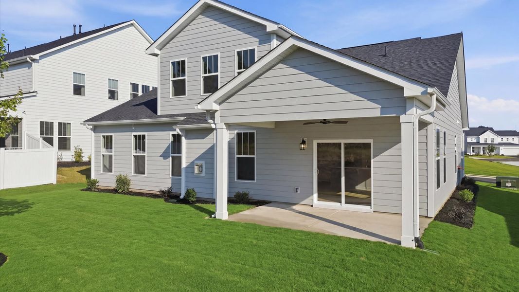 Highly functional rear covered porch adds memorable living space to this elegant home located at Wells Crossing