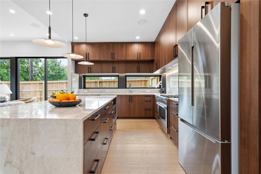 Culinary dreams come alive in this meticulously appointed kitchen featuring an expansive island.