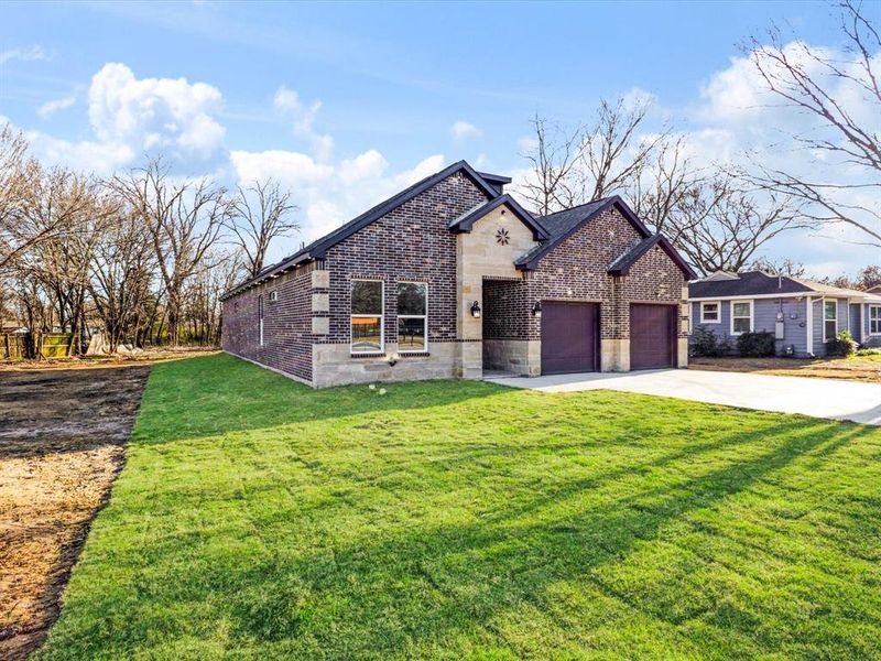 View of front facade with brick siding, concrete driveway, a front lawn, and an attached garage View of front facade with brick siding, concrete driveway, a front lawn, and an attached garage
