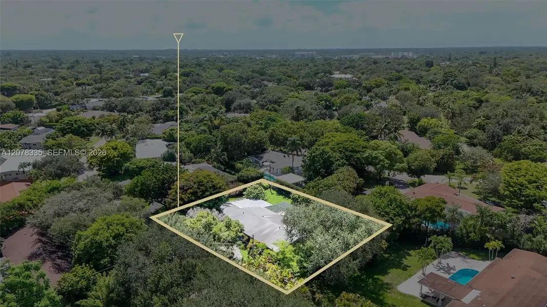 Bird's-eye view capturing the property's private pool, backyard space, and quiet residential setting.