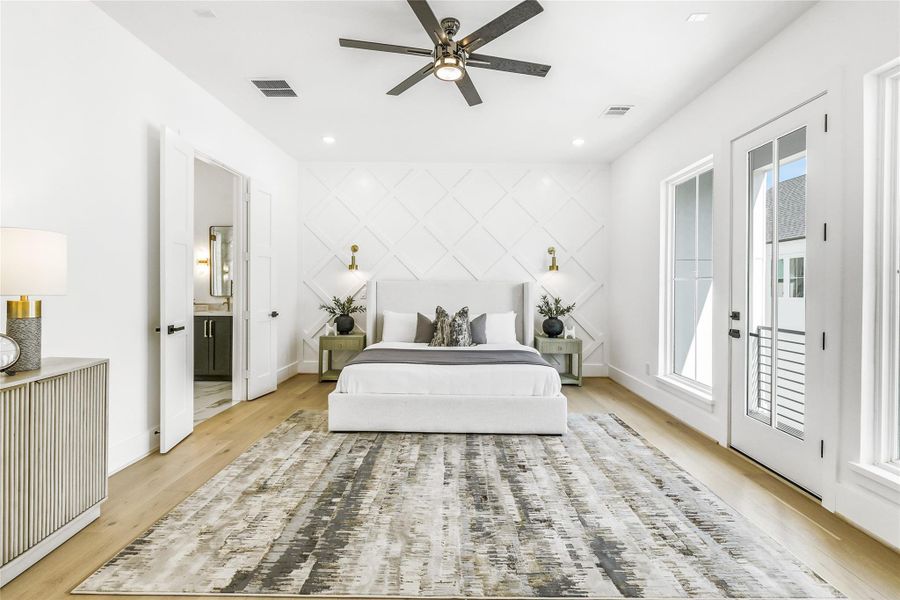 The third-floor primary suite delivers a serene sanctuary bathed in natural light, with custom millwork accent wall, designer sconces, and wide-plank European oak flooring. Soaring ceilings and double French doors open to a private terrace, creating a tranquil retreat ideal for quiet mornings or evening relaxation. Every element is crafted for elegance and function—from the solid-core double doors to the luxury fan and recessed lighting that define the room’s understated sophistication.