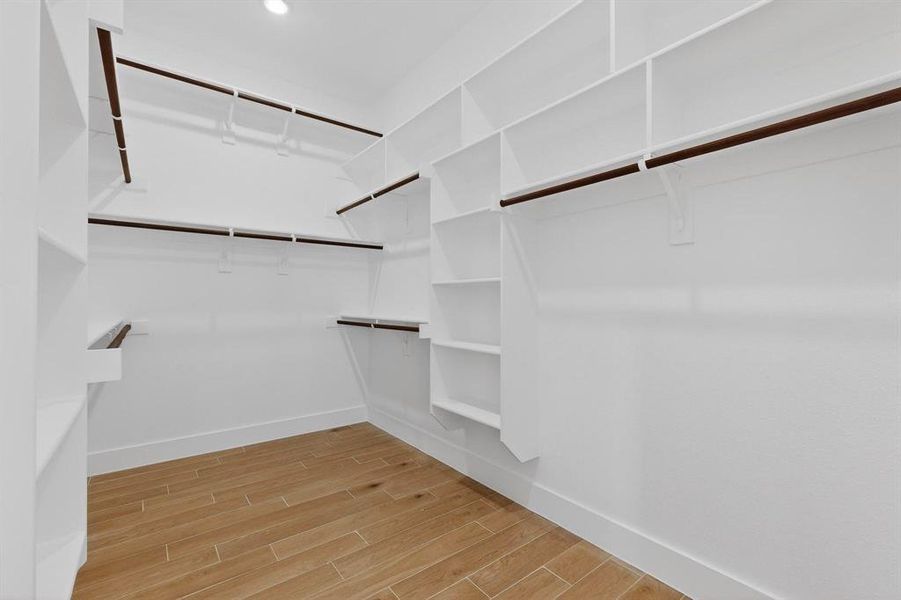 Walk in closet with wood tiled floors