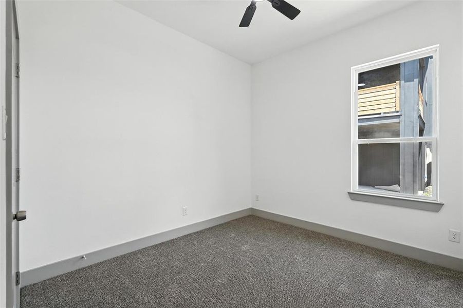 Unfurnished room with carpet flooring and ceiling fan Unfurnished room with carpet flooring and ceiling fan