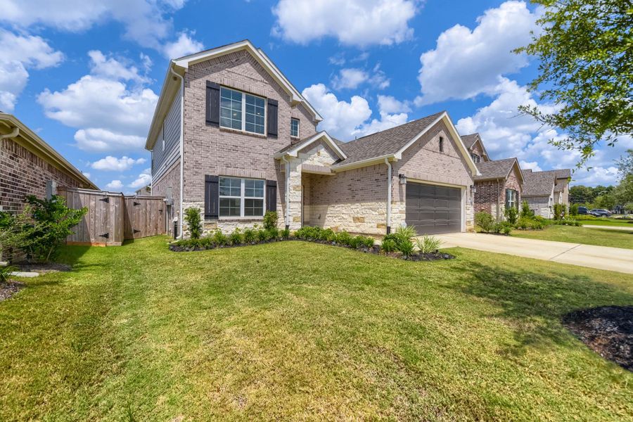 Front exterior of a new home in Sorella, Tomball, TX, highlighting curb appeal (Image 2). Front exterior of a new home in Sorella, Tomball, TX, highlighting curb appeal (Image 2).