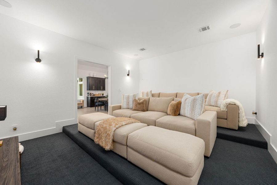Grab the popcorn, put on a movie, and enjoy a wonderful evening in your amazing media room! Featuring plush carpet, custompaint, custom lighting makes this the perfect room for relaxing!