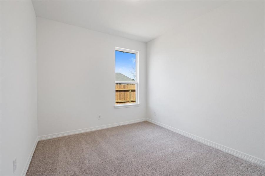 Your secondary bedroom features plush carpet, fresh paint, closet, and a large window that lets in plenty of natural lighting.