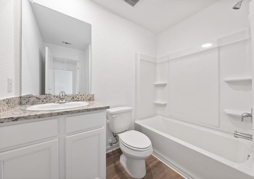 Secondary bathroom with a dual shower and tub.