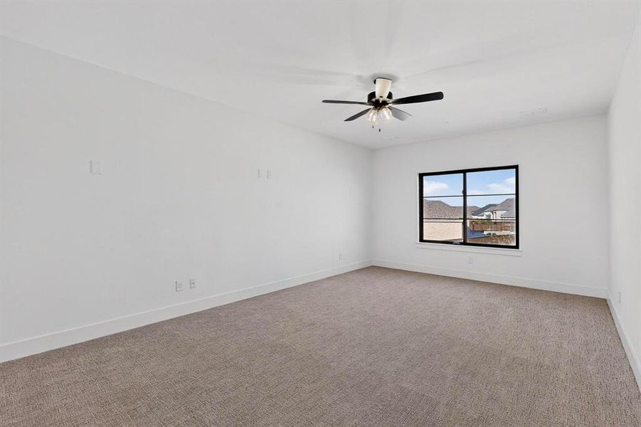 Private media room with barn door off game room with flexible uses.