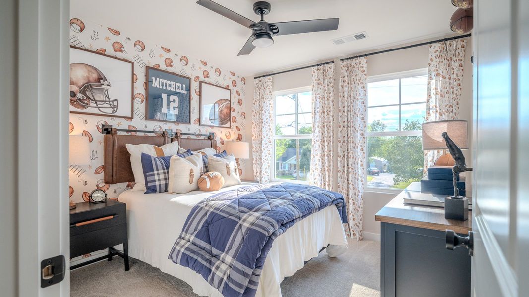 Secondary bedroom with carpet and windows