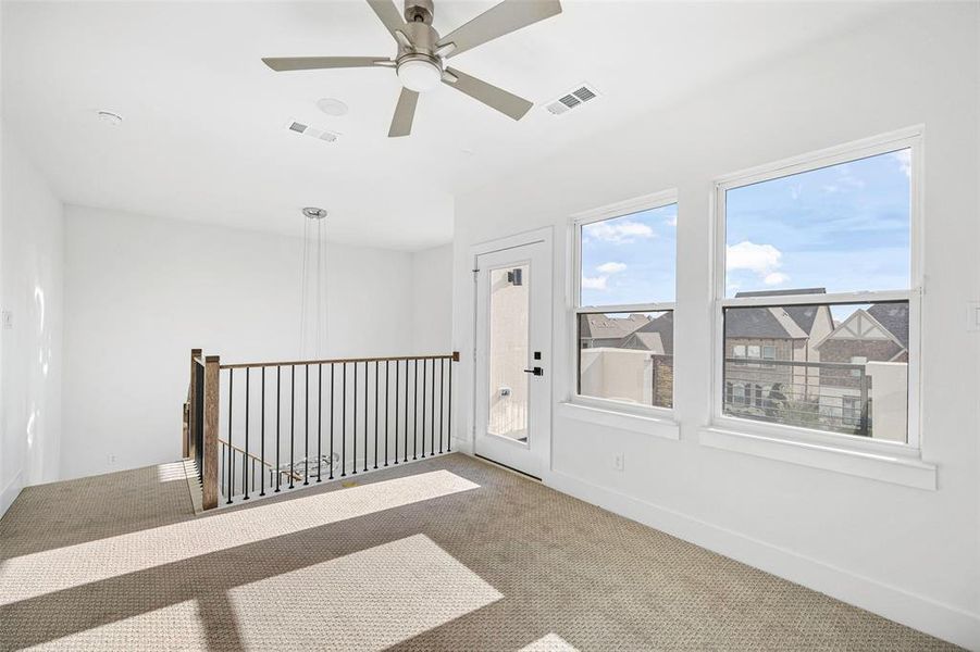 Empty room with a ceiling fan, carpet, visible vents, and baseboards