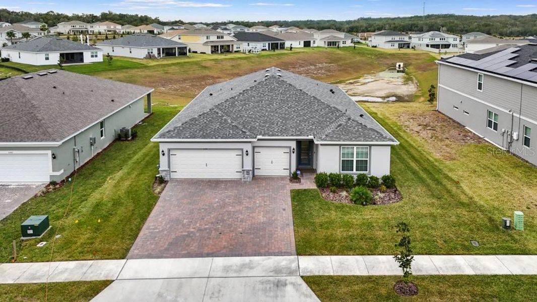 Front exterior of a new home in Foothills Preserve, Mount Dora, FL, highlighting curb appeal (Image 26).