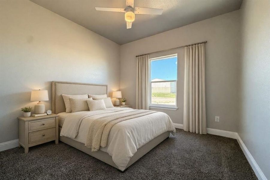 Bedroom featuring ceiling fan and dark colored carpet