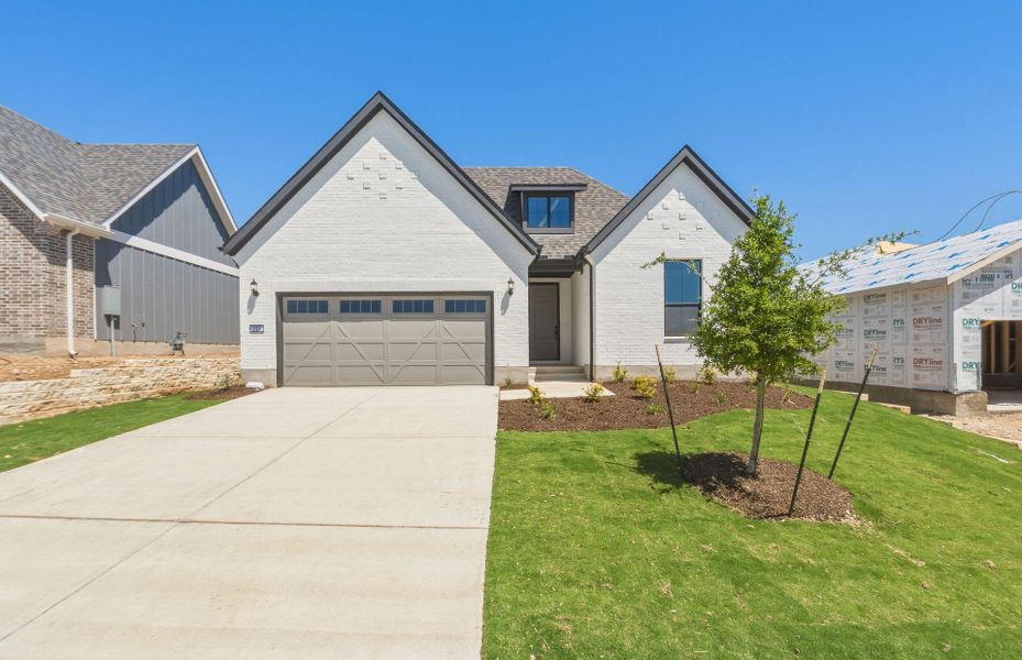 Front exterior of a new home in Sun City Texas, Georgetown, TX, highlighting curb appeal (Image 21).