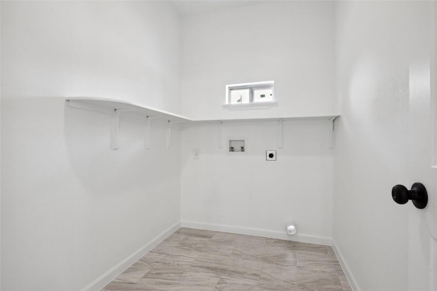 Laundry area with washer hookup, light marble finish floors, baseboards, and electric dryer hookup Laundry area with washer hookup, light marble finish floors, baseboards, and electric dryer hookup