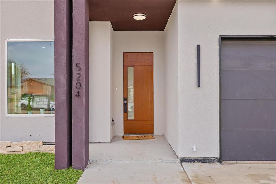 Property entrance featuring stucco siding Property entrance featuring stucco siding