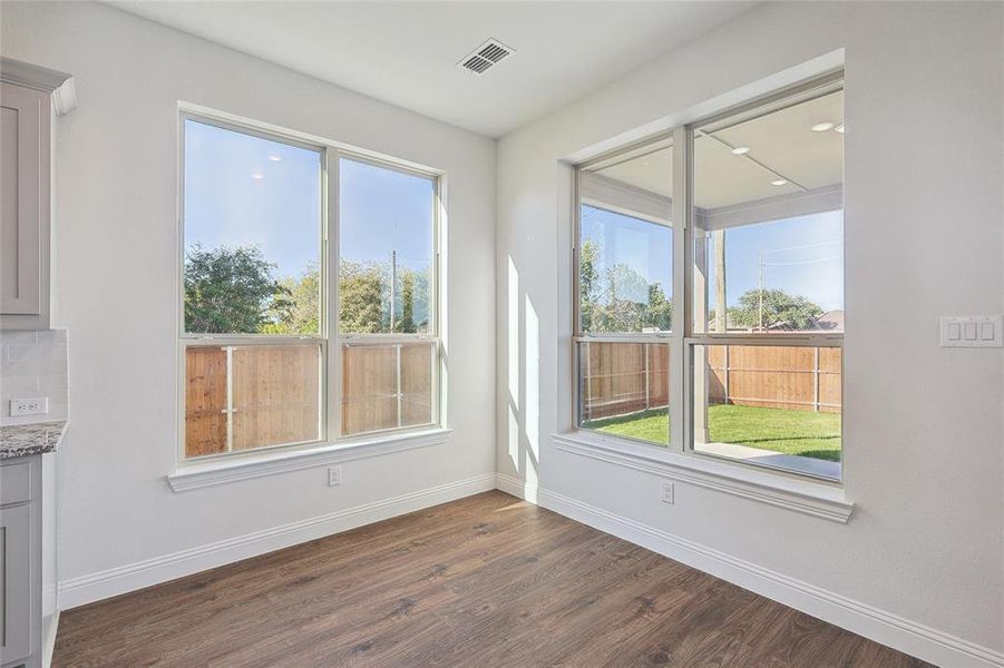 Unfurnished dining area featuring dark wood-type flooring