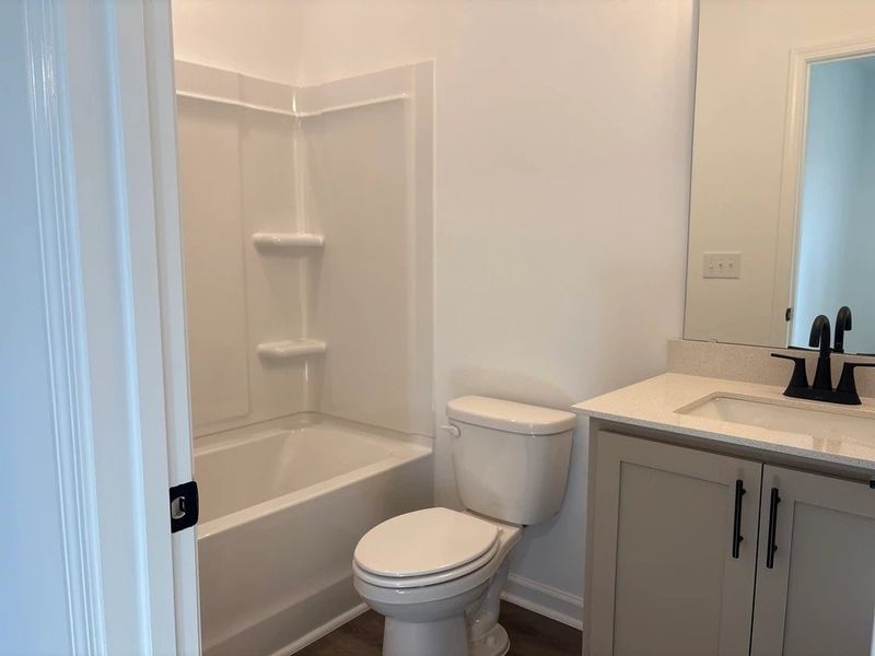 Bath 2 featuring the AW Collection® Foundry - Strong lines and deep tones define the space.