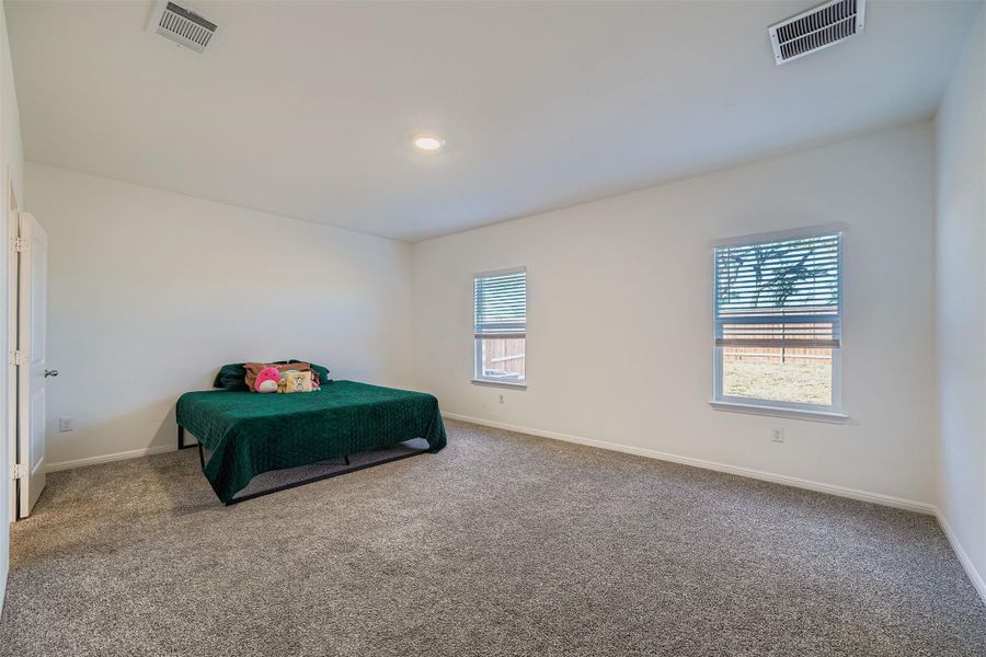 Carpeted bedroom with baseboards and recessed lighting