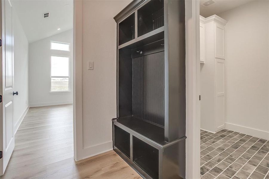 Mudroom with lofted ceiling and wood-type flooring