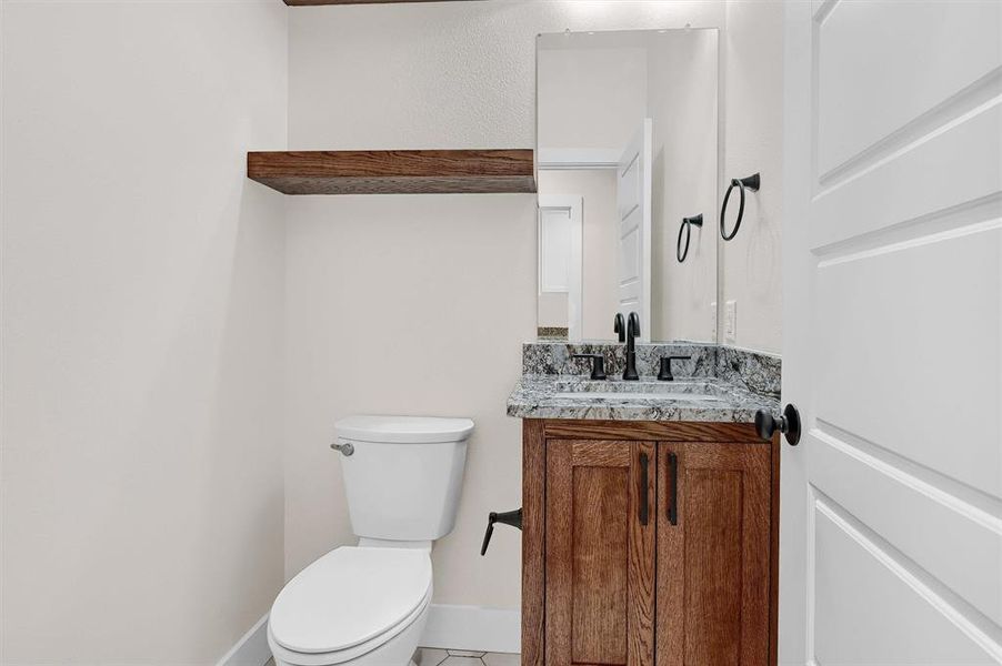 Bathroom with tile patterned floors, vanity, and toilet