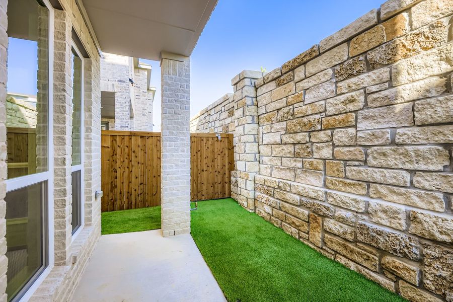 Exterior details and patio area of a home in Castle Hills Northpointe - Townhomes, Carrollton (Image 3). Exterior details and patio area of a home in Castle Hills Northpointe - Townhomes, Carrollton (Image 3).