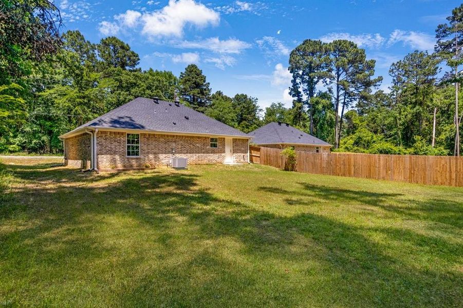 Rear view of property with brick siding Rear view of property with brick siding