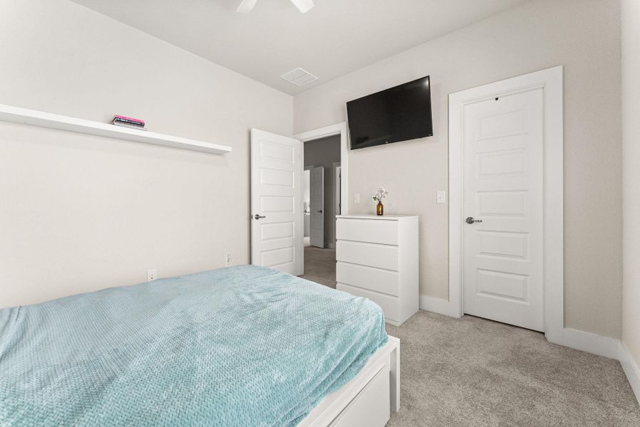 The fourth bedroom features a walk-in closet, ceiling fan with light fixture, and a TV mount.