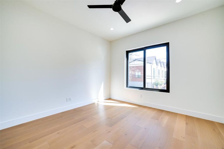 Spare room with light hardwood / wood-style floors and ceiling fan